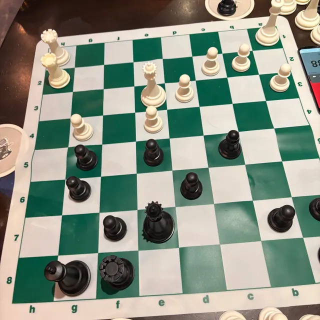 Photo of a green roll-up tournament board seen from Black's side